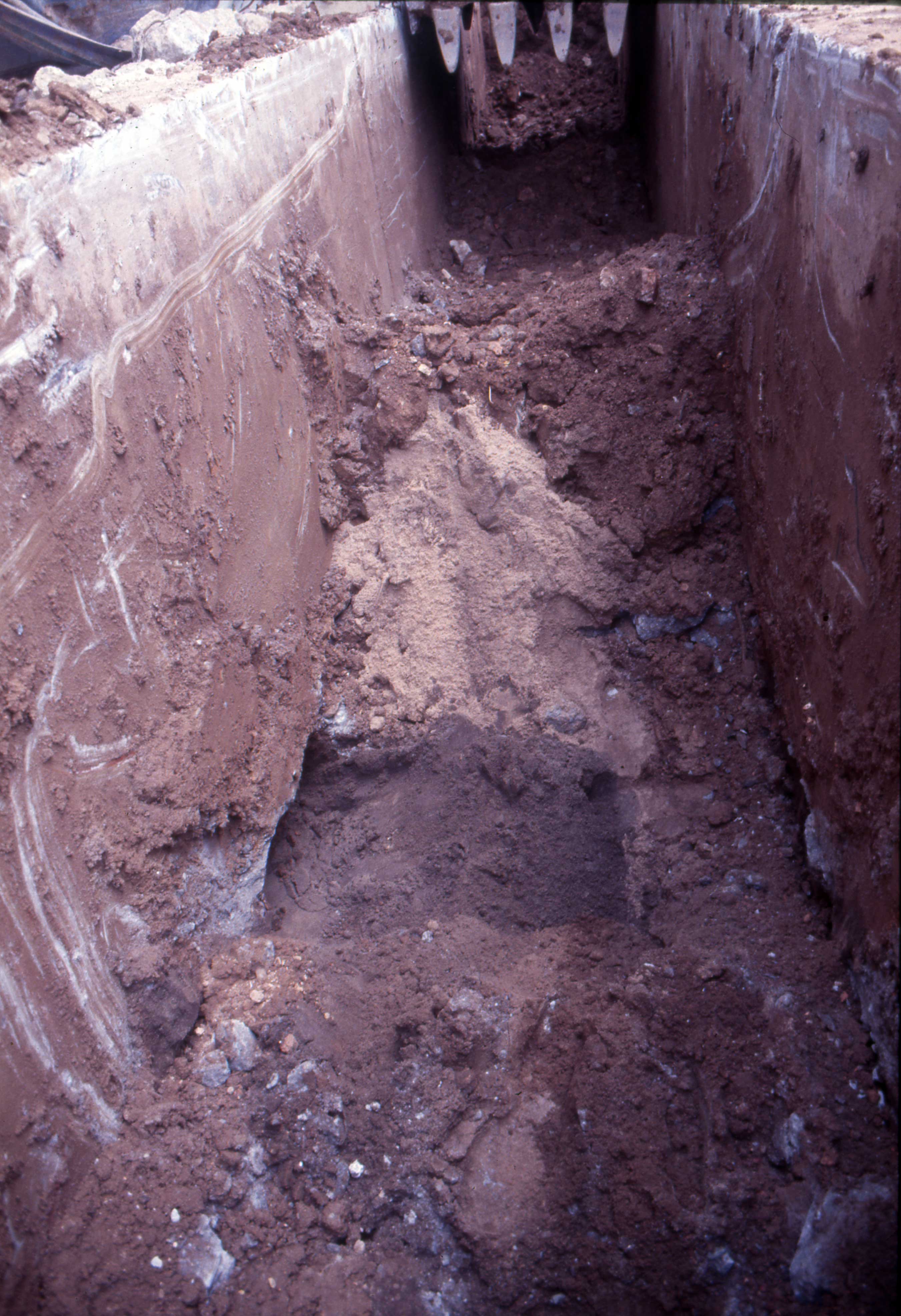July 18 2000 trench excavated by backhoe. Black sand visible in lower centre.