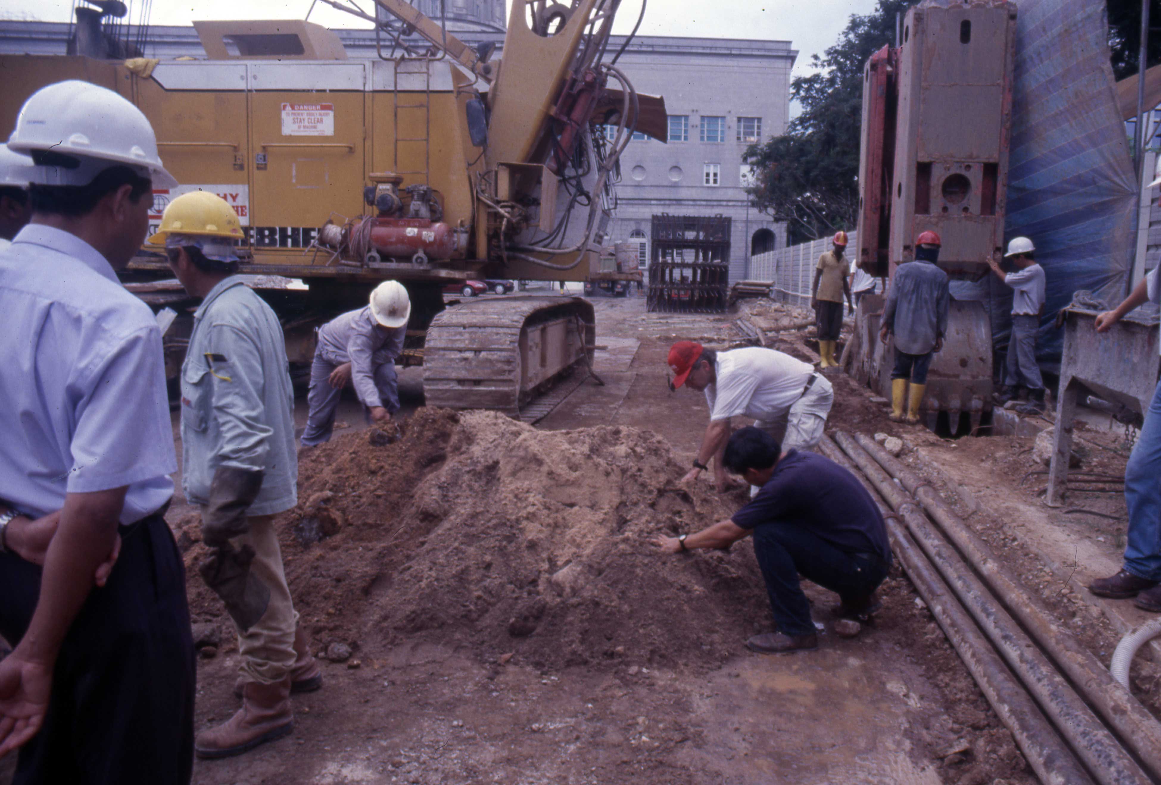 July 18 2007 Dr. Miksic and Mr. Ng Ching Huei investigating soil excavated by the large backhoe.
