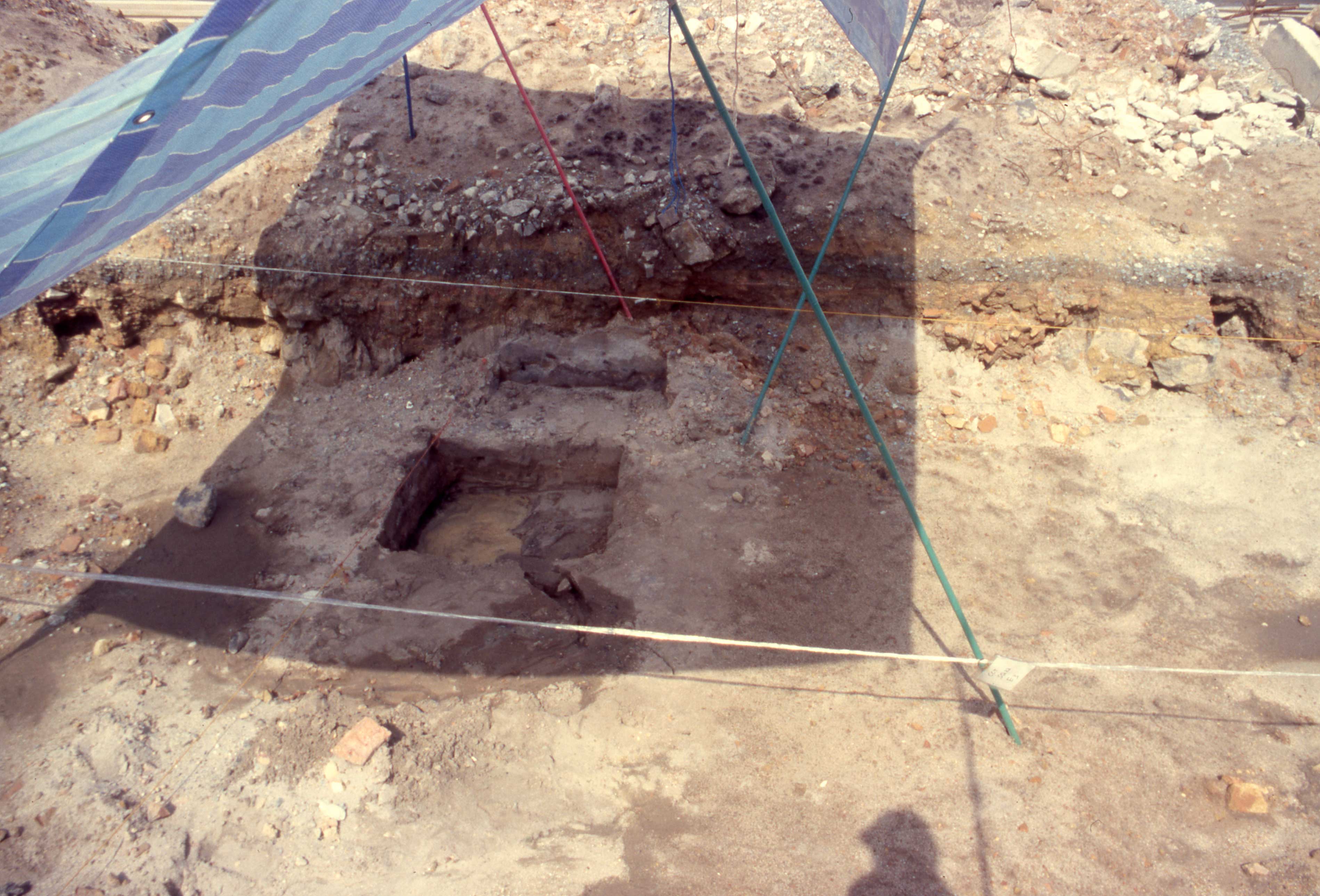 Excavation in progress with groundwater visible.