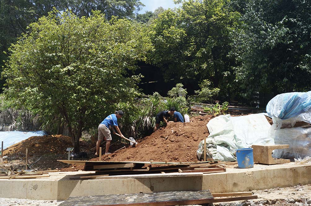 Figure 7. Goh and two student research assistants going through the deposited soil looking for artefacts (12 April 2019)
