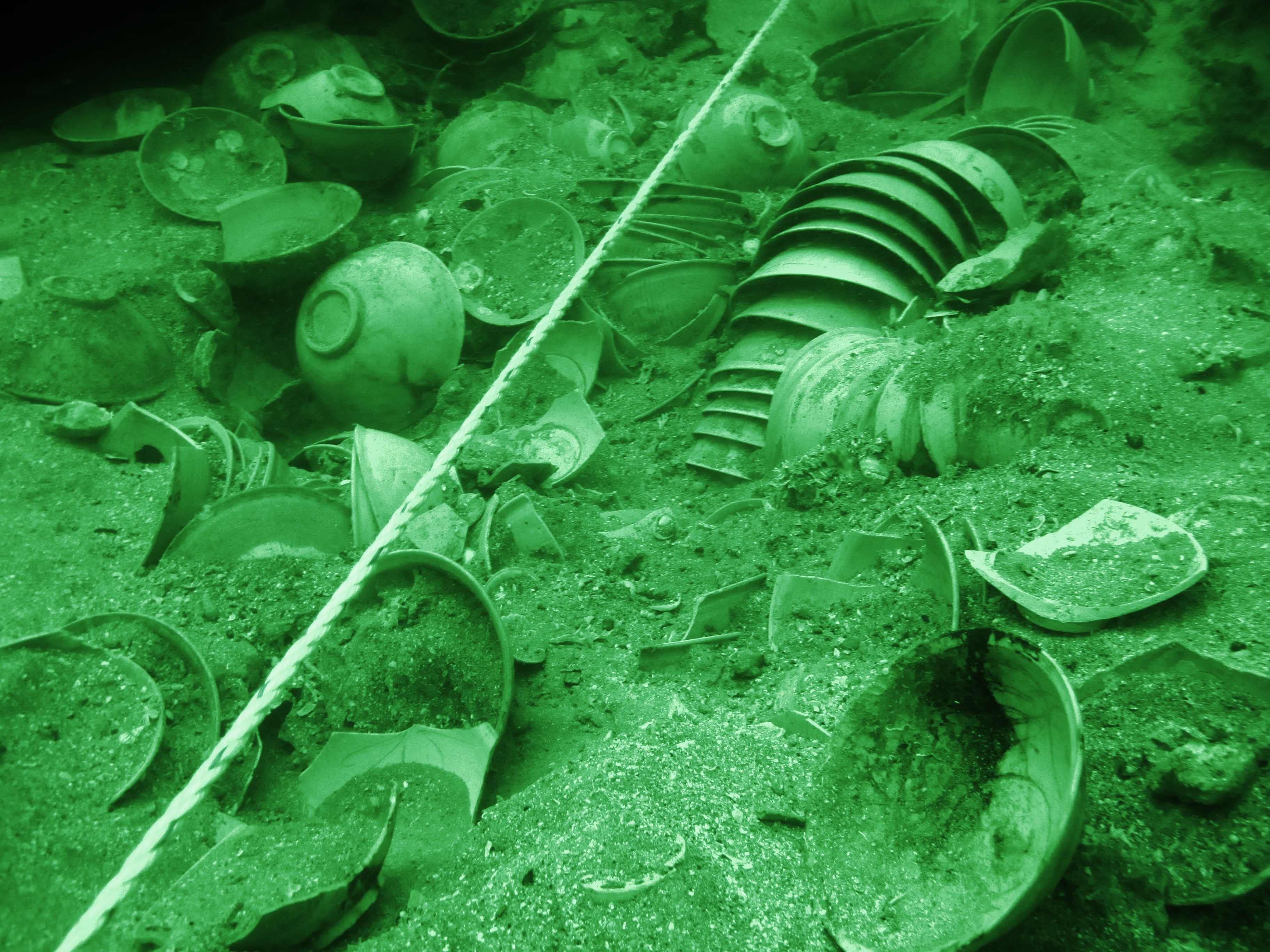 Stacks of bowls revealed under the centre-line rope after a layer of sand was removed by air-lifting.