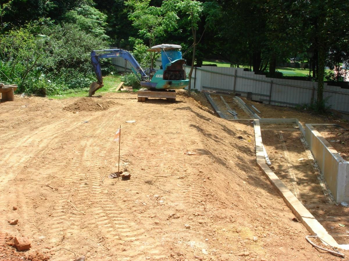 Figure 2. Backhoe at the Fort Canning Spice Garden (FTCSG) site, 7 April, 2010. Fort Green is in the background. The concrete foundations on the right of the image are for the wheelchair ramp construction