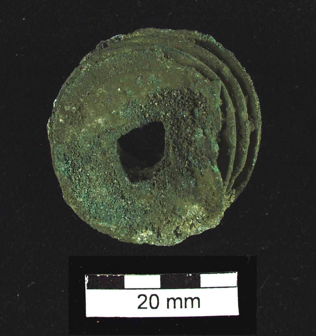 Figure 19: A number of Chinese coins which had become fused together as a result of having been subjected to high temperature. Two possible explanations are either: 1. The coins were being smelted and recycled for making other metal implements or 2. The coins were in a location which was exposed to high fires.